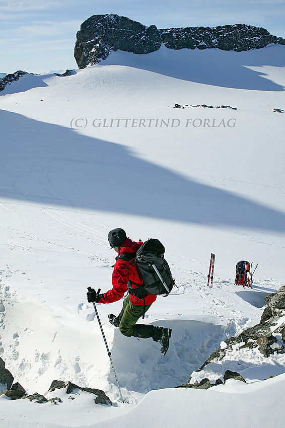 Et elegant hopp fra Galdhøpiggens nordøstrygg og ned på snøfonna øverst på Styggebrean. Vesle Galdhøpiggen (2369 moh.) i bakgrunnen.