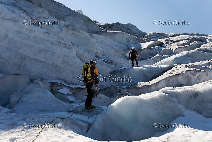 Hikers on Storjuvbrean glacier. Jotunheimen National Park. Norway.