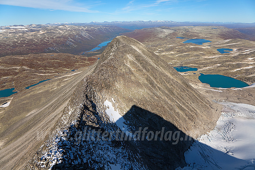 I nordryggen på Tverrådalskyrkja mot nordtoppen. Tverrådalskyrkja kaster en lang pyramideskygge. Til høyre ses en liten del av Fortundalsbreen og i det fjerne ses Liavatnet hvor Sota Sæter ligger.