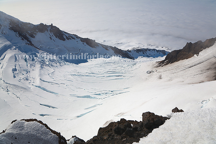 Utsikt fra Hakluyttoppen ned Weyprechtbreen som sprenger seg ut av krateret på Beerenberg. På andre siden av breen ses Kongshamaren.