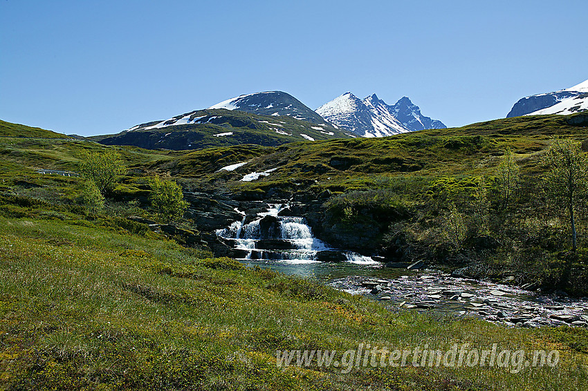 Ved broa over Helgedalselvi like ved Turtagrø med det kjente panoramaet bestående av Nørdre, Midtre og Store Skagastølstinden, i bakgrunnen. Kulpen på bildet er herlig å bade i på varme sommerdager.