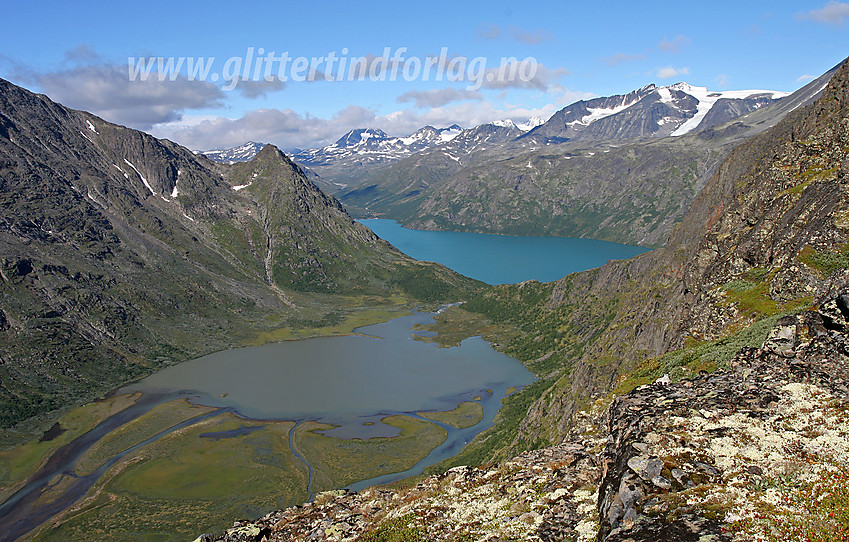 På vei over Knutshøe en flott sommerdag med toppen til høyre i bildet. Nedenunder ses Øvre Leirungen, mens Gjende ligger bakenfor. I bakgrunnen til høyre ruver Surtningssue.